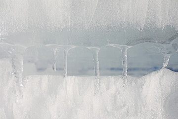 Naklejka na ściany i meble Texture of ice on a spring day under the sun.