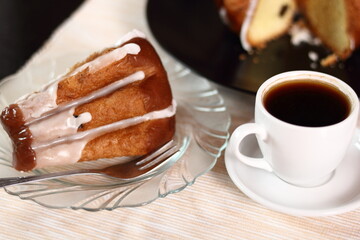 Cake with sugar icing and coffee cup