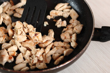 Fried chicken fillet in skillet. Making Chicken and Egg Galette Series.