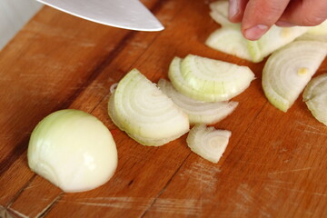 Chef slicing onion. Making Chicken and Egg Galette Series.