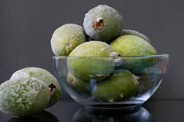 Composition of frost feijoas in bowl on grey background. Source of iodine and vitamin C.