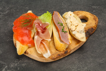 Tapas - bruschetta with prosciutto, salmon, duck and gorgonzola