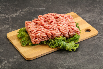 Raw pork minced meat over board