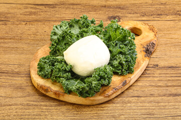 Soft mozzarella cheese over board