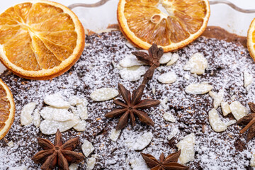 Tart with poppy seeds and fruit sprinkled with powdered sugar