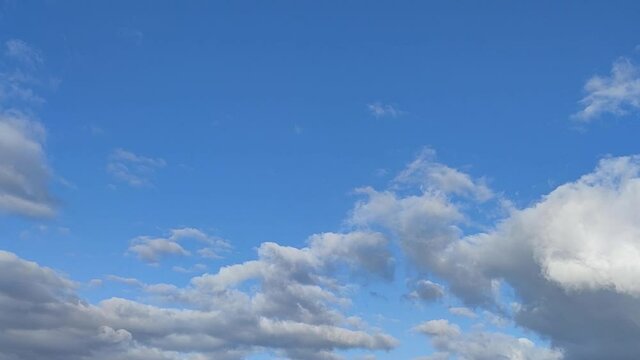 Time lapse of rain clouds on blue sky