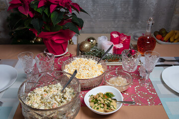Laid table, salad Olivier, traditional Russian dish for New Year