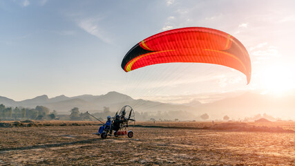 Silhouette picture of the Paramotor Flying through sunlight Sky Sunset,Freedom conept,copy space....