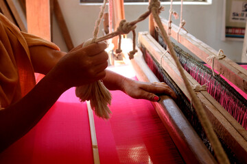 Handloom weaver in India working in her loom