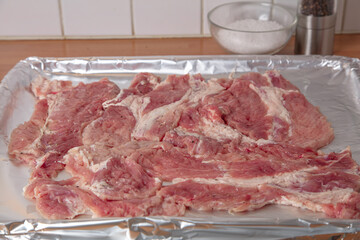Pork chops, slices, on a baking sheet