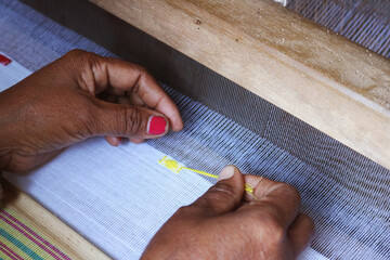 Handloom weaver in India working in her loom