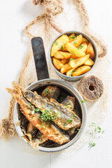 Top view of fried herring fish with salt and herbs