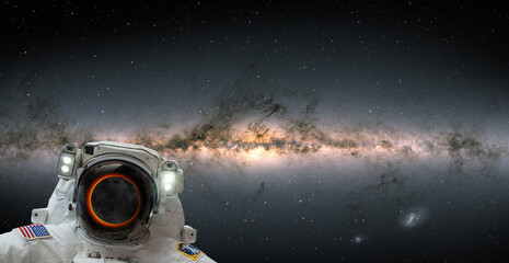 An astronaut watching the Solar Eclipse in space with milky way galaxy 