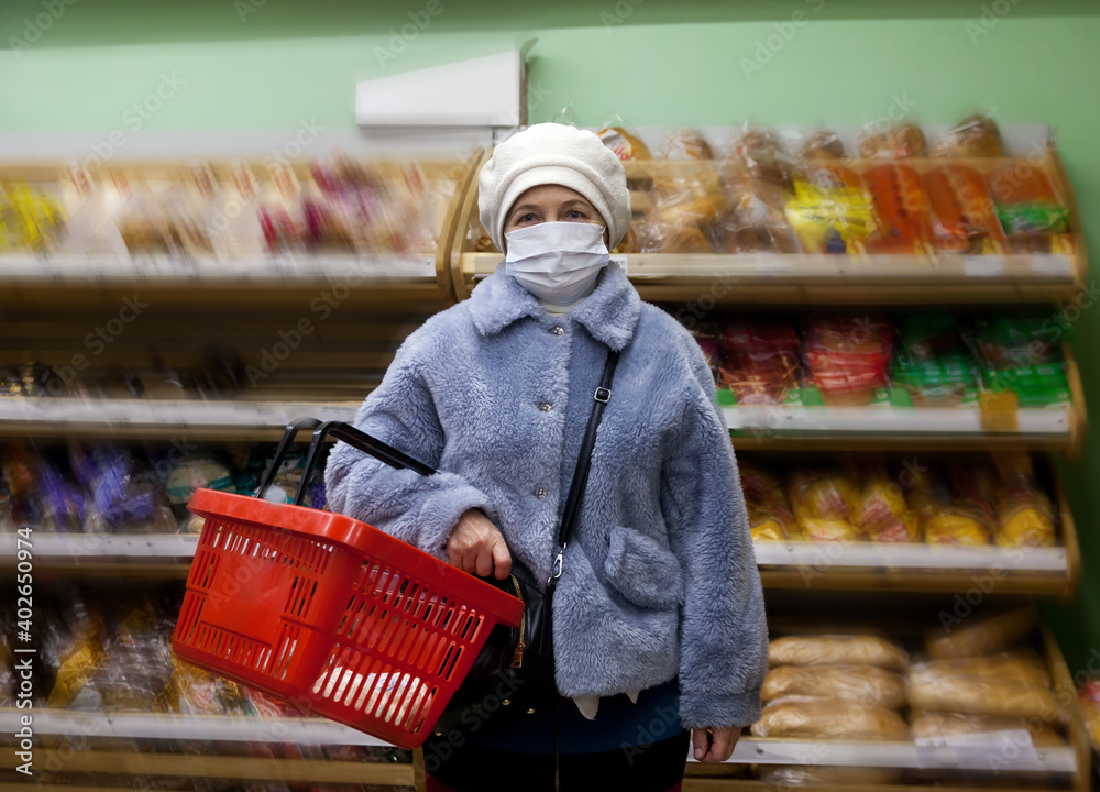 Wall mural Woman wearing face mask  shopping  in  supermarket -active elderly pensioners