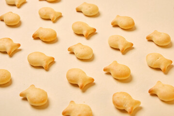 fish crackers on beige background top view