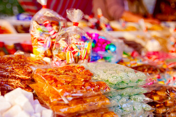 Selling colorful candies and sweets at the fair on stall, street market