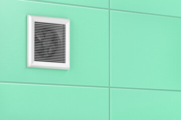 Exhaust fan mounted on the tiles in the bathroom