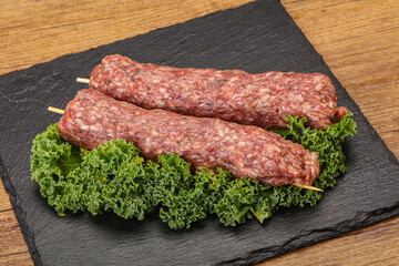 Raw minced beef kebab skewer