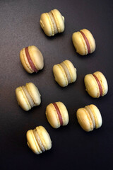 Banana yellow macaroons on black background