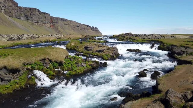 Iceland nature with Icelandic moss near river with a small waterfall.