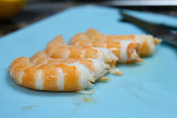 peeled shrimp on a blue background