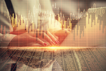 Double exposure of businesswoman hands typing on computer and financial graph hologram drawing. Stock market analysis concept.