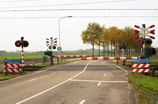 Railway crossing with closed barriers in Arnhem, Netherlands