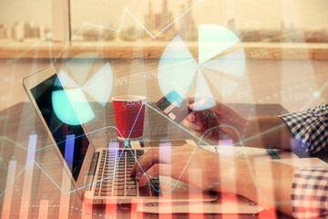 Double exposure of man hands holding a credit card and Forex graph drawing. Stock trading and digital fintech in Internet E-commerce concept.