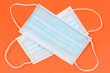 some surgical masks isolated on orange background