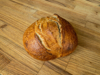 Whole wheat sourdough bread on a wooden surface