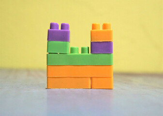 Plastic building blocks on wall background