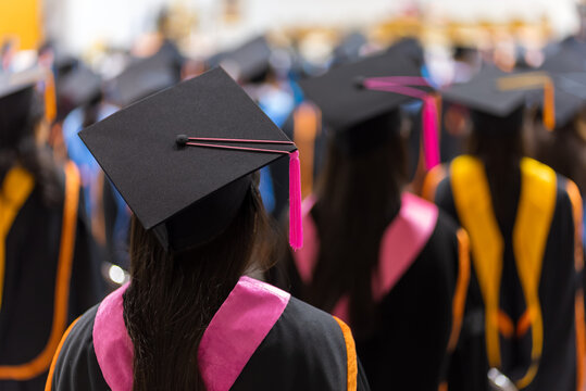 The back of the graduates are walking to attend the graduation ceremony at the university.