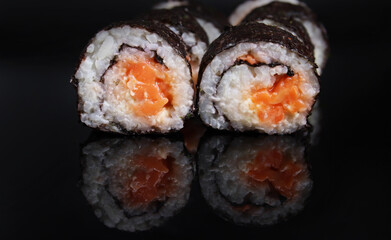 fresh delicious sushi rolls on a mirror surface