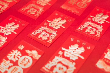 Chinese wedding gift red packets neatly arranged on red background