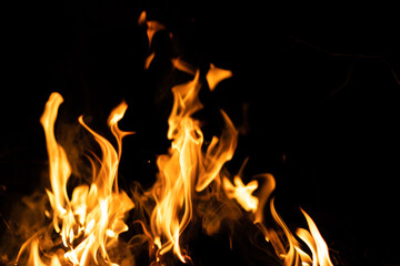 Fire flames on a black background. Abstract fiery texture. Realistic fire flames burn movement frame. Texture for Design. The texture of fire. Fire flames background. Blazing campfire. Sensitive focus