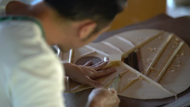 craft man making guitar on wood table, capenter working concept