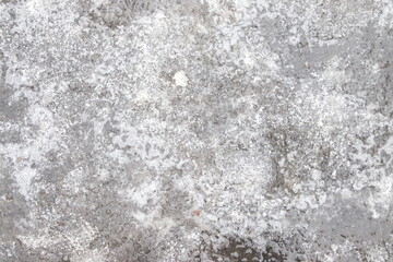 Cracked ice on concrete with yellow leaves. Yellow leaves and concrete can be seen under the cracked ice