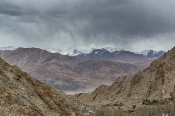 Himalayas mountain covered with snow, and background of cloudy sky, view from the Hemis monastery, near the Leh city, Ladakh, Jammu and Kashmir