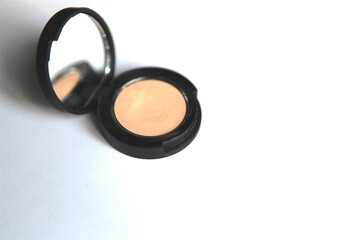 Isolated beauty compact make-up beige cream concealer with mirror for glamour and luxury feeling good and fresh on white background for self-care and fashion spa or professional application