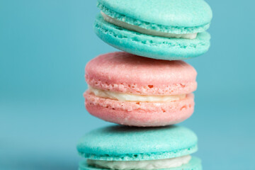 Colorful sweet macarons on a blue background
