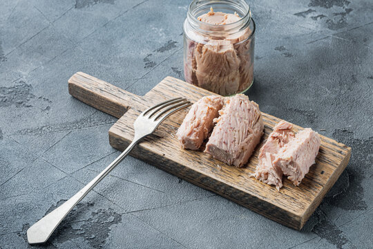 Canned tuna fillet in olive oil , on gray background