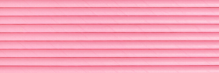 Pink abstract background made of drinking paper straws. Banner for website.