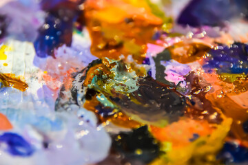 Obraz na płótnie Canvas multicolored palette with pieces of oil acrylic paint macro abstraction background