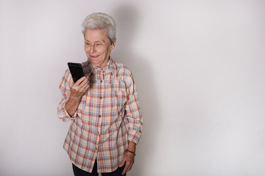 Grandmother talking on her mobile phone.Technology, communication and aged people concept