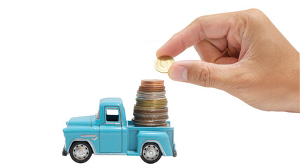 A coin handle and placed on a coin stacked on the back of a toy car on a white background or isolate. Concept of sell car, buy, rental, insurance.