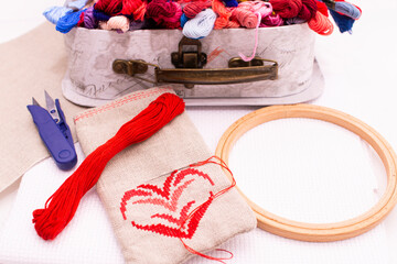 The embroidery bag is next to the thread box.