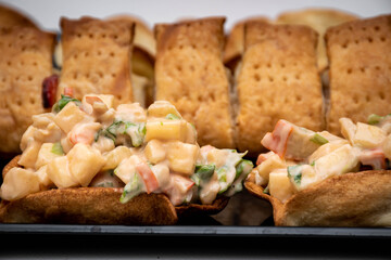 Horizontal view of puff pastry and crab cocktail tops. Crab, apple, pineapple and crab salad con white background