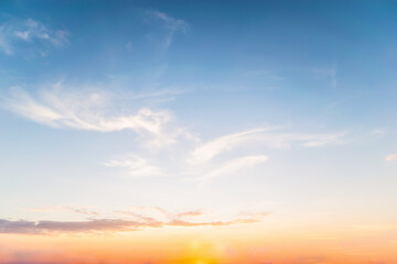 Sky blue and orange light of the sun through the clouds in the sky