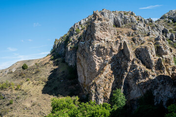 Fototapeta na wymiar Arroyo Boqueron, Valle de Tabladillo, Segovia. limestone rock mountain with green trees