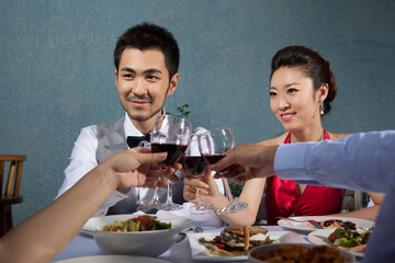 Four people sit together for dinner and chat
